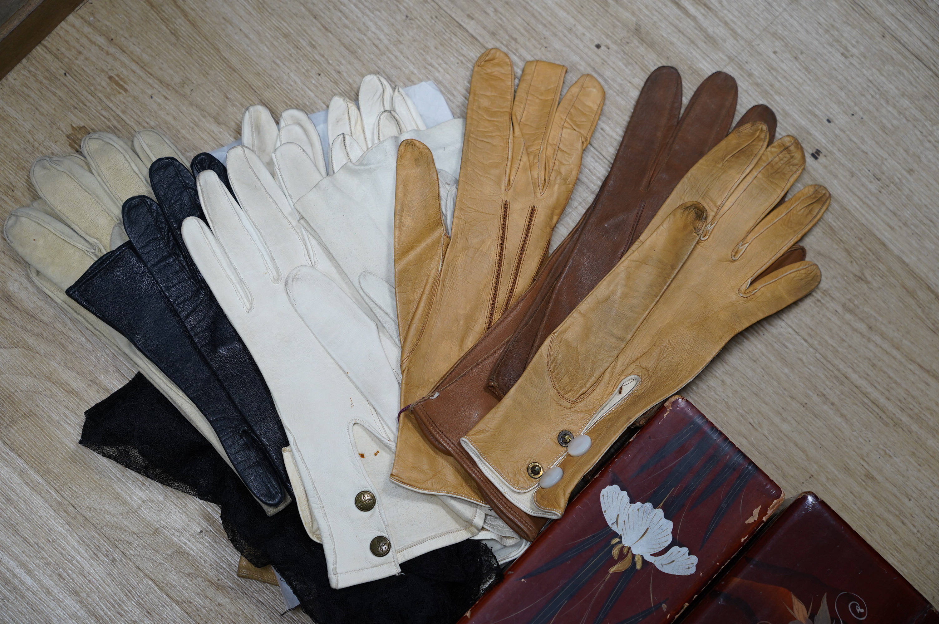 Twenty seven pairs of mostly leather gloves and three lacquered glove boxes, 29cm long. Condition - fair to good